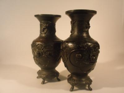 A pair of early 20thC Japanese bronze baluster vase cast in relief with