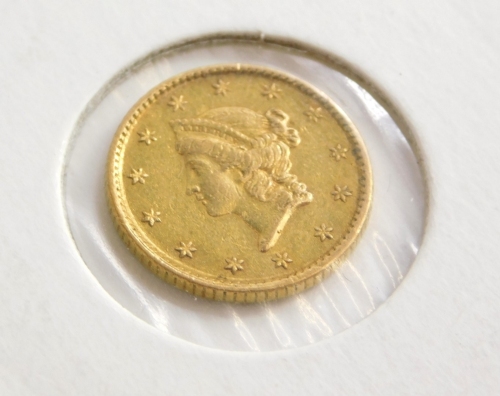 An 1854 gold USA one dollar, in presentation sleeve.