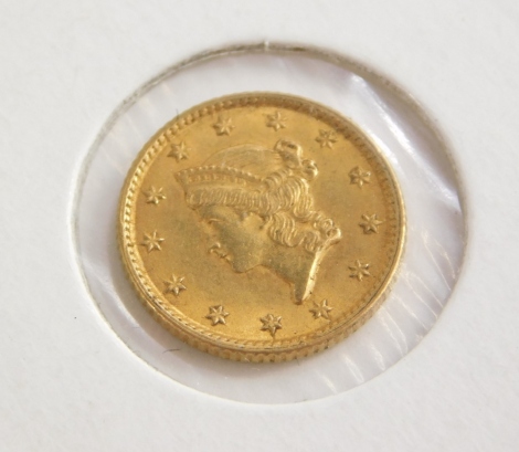 An 1854 gold USA one dollar coin, in presentation cardboard sleeve.