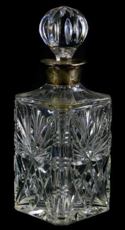 A cut glass decanter and stopper, with silver collar, Birmingham 1968, 27cm high.