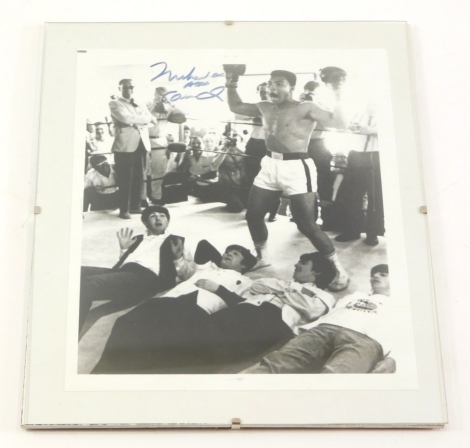 A black and white photograph bearing signature for Mohammed Ali, pictured with The Beatles, with a certificate of authenticity from Championship Sports Promotions, Jersey City WJ 07306.