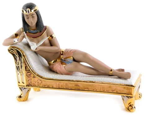 A Nadal porcelain figure of a reclining nude Cleopatra, 41cm long.