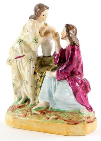 A 19thC Staffordshire figure group, depicting Jesus and Mary Magdalene, on canted rectangular base, 15cm high.