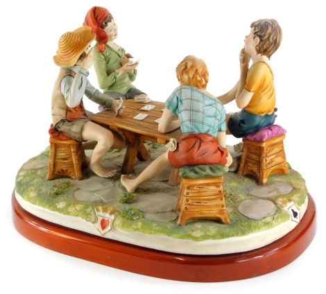 A Capodimonte porcelain group The Cheat, indistinctly signed and numbered 330, on a wooden base, 42cm wide.