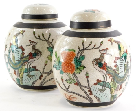 A pair of Chinese porcelain ginger jars, each decorated with famille enamels with insects, Asiatic pheasants, flowers, etc., impressed marks to underside, 22cm high.