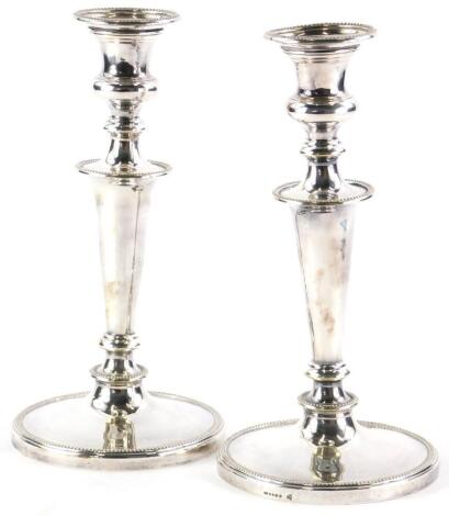 A pair of silver plated candlesticks, of tapering form with beaded borders, 25.5cm high.