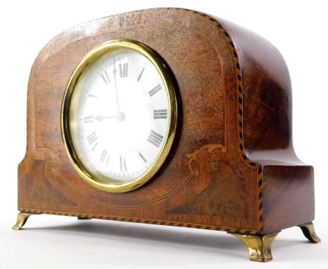 An early 20thC mahogany and marquetry mantel timepiece, the enamel dial stamped France, on brass bracket feet, 21cm wide.