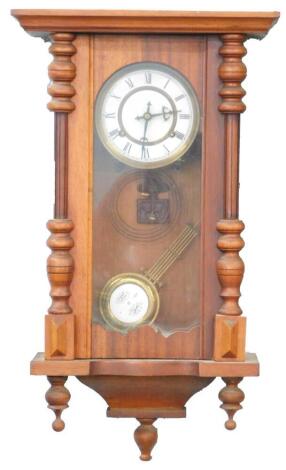 An early 20thC mahogany cased Vienna type wall clock, with white enamel dial, 65cm high.