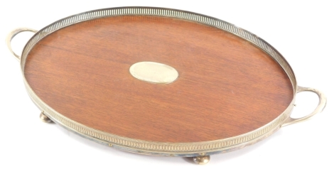 A silver plated and mahogany galleried tray, with vacant oval cartouche, 61cm long.