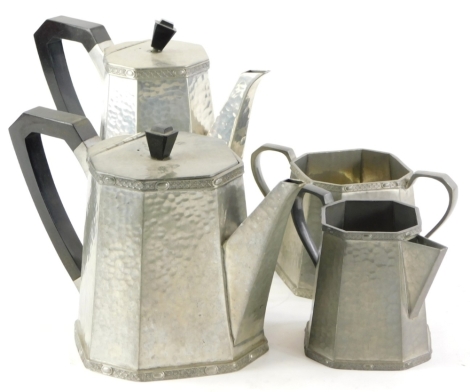 An Art Deco hand beaten pewter four piece coffee service, of angular form with black Bakelite handles.