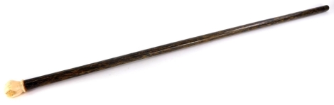 A late 19thC walking cane, with tapering shaft, possibly palm wood, and a carved ivory hand shaped handle, 91cm long.