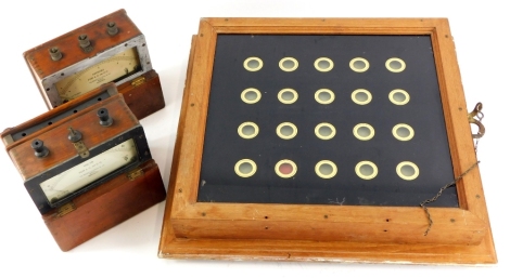 A servant's board, with verre eglomise decoration, with a hardwood casing, 18cm wide, and two amp meter and a volt meter.