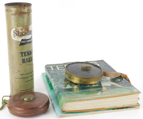 A collection of tennis related items, to include a lawn tennis measure in brass case, a leather cased Chesterman tape measure, a Lawn Tennis Championship Centenary programme for 1977, the Encyclopedia of Tennis and an unopened canister of Slazenger tennis