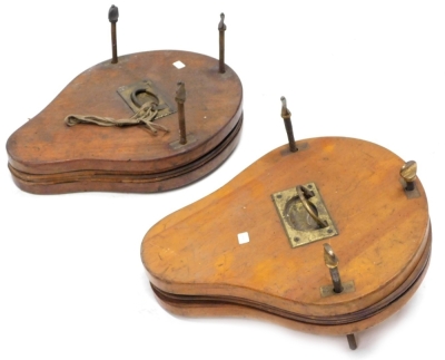 Two similar late 19thC mahogany and brass pear shaped tennis racket presses, each with an inset handle, 38cm long.