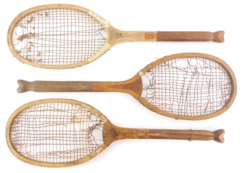 Three early 20thC Slazenger The Demon tennis rackets, each with a fishtail handle.