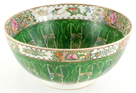 A Chinese Canton bowl, decorated with dragonflies, birds, flowers, in green and red, six character mark to underside (AF) 35cm diameter.