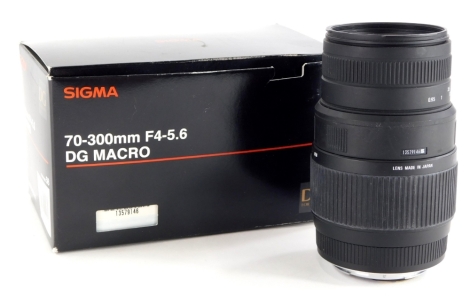 A Sigma 70-300mm DG macro lens, with original box and packaging.