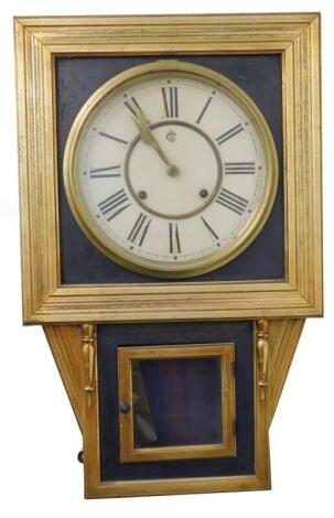 A late 19thC American Waterbury Clock Company Orient design drop dial wall clock, with painted dial, the gilt case with ebonised panels, makers label to reverse, 63cm high, 39 wide.