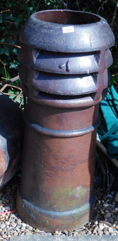 A stoneware chimney pot, with pierced decoration to the top, 88cm high.