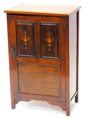 An Edwardian rosewood and marquetry music cabinet, the rectangular top with a moulded edge above a single panelled door, decorated with urns, flowers etc., on square section legs, with brackets (AF), 86cm high, 54cm wide.