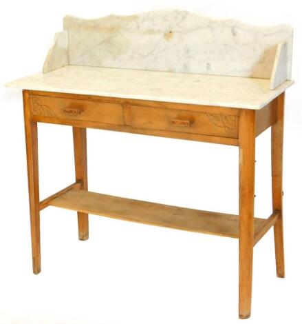 An Art Deco beech washstand, with a white marble top, with two frieze drawers on tapering legs with under tier, 100cm wide.