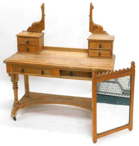 A Victorian ash Gothic dressing table, the top with two trinket drawers to each support, holding a rectangular mirror plate, the base with a moulded edge above two frieze drawers, on turned end supports with concave under tier (AF), 122cm wide.