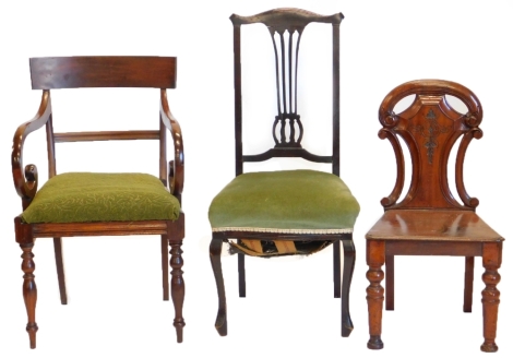 A Victorian mahogany hall chair, with a shield shape back, a 19thC mahogany open arm chair, and an Edwardian side chair with padded seat. (3)