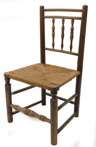 A 19thC oak and ash country made side chair, with a spindle turned back, woven seat on turned legs with stretchers.