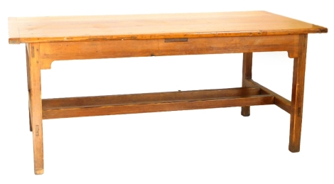 A 19thC French farmhouse kitchen table, the planked top with cleated ends, on square tapering legs with stretcher, 78cm high, the top 180cm x 98cm.