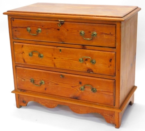 A pine chest of drawers, top with a moulded edge, above three long drawers with brass drop handles on bracket feet, 78cm high, 90cm wide, 45cm deep.