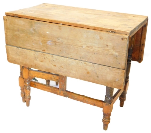 A 19thC scrub top pine gateleg kitchen table, with drop leaf.