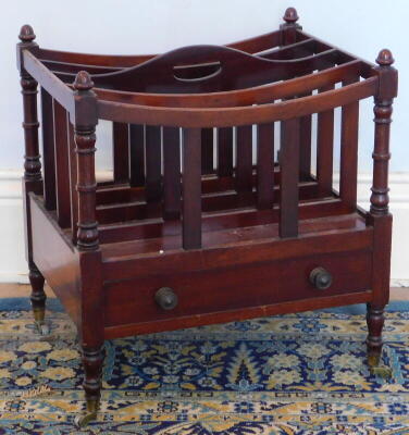 A Victorian mahogany Canterbury, with turned uprights single drawer and brass cup castors, 50cm wide.