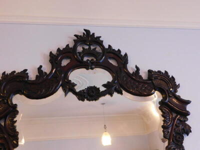 A 19thC carved rococo wall mirror, with c and s shaped scrolls, around a bevelled plate, 135cm high, 110cm wide. - 2