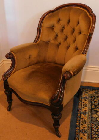 A Victorian carved walnut show frame spoon back open armchair, with scroll legs.