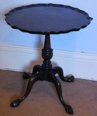 A Georgian mahogany style occasional table, with a pie crust top and four out splay legs, with ball and claw feet, 46cm wide.