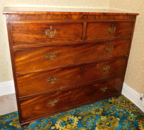 A George III mahogany chest, of two short and three long graduated drawers, with brass swan neck handles and turned feet, 116cm wide.