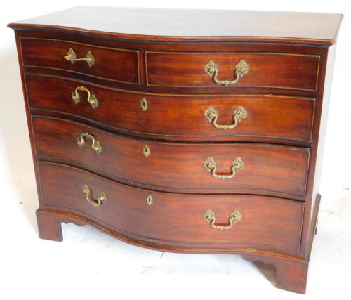 A George III mahogany serpentine chest, of two short and three long graduated drawers, oak lined and cock beaded with brass cast loop handles and bracket feet, 85cm high, 105cm wide, 60cm deep.