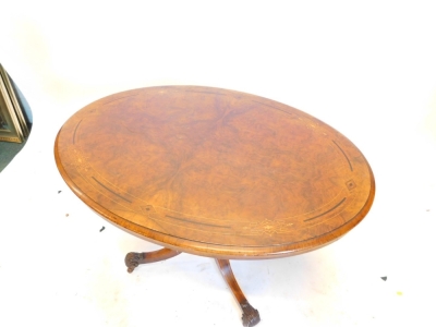 A Victorian walnut and marquetry loo table, with oval top cross banded with amboyna and ebonised panels, turned supports and four sabre legs with acanthus scroll cap feet and castors, 115cm x 76cm. - 2