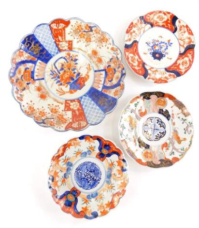 A Japanese Imari circular scalloped shaped charger, a similar later dish and two others. (4)