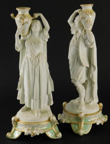 A pair of late 19thC French porcelain figural candlesticks, stamped Brevete, (AF).