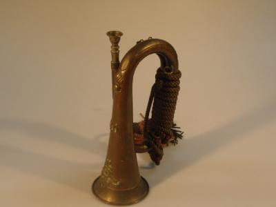 A Royal Artillery copper and brass bugle with tasselled cord