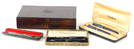 A small collection of pens, a Parker fountain pen, blue with matching propelling pencil, cased, a pen stamped Mentmore, a Golden Platignum (lacking lid), a propelling pencil, Platignum pen box, a single pen box and a rosewood box, possibly for drawing ins