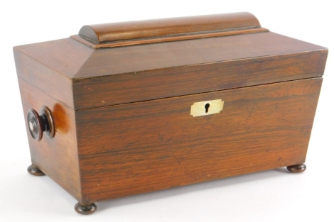 A Victorian rosewood tea caddy, of sarcophagus form, with two domed top compartments and mixing jar, with key, 37cm wide.