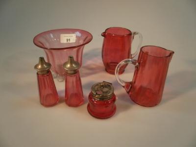 A cranberry glass sugar bowl with clear glass prunt foot