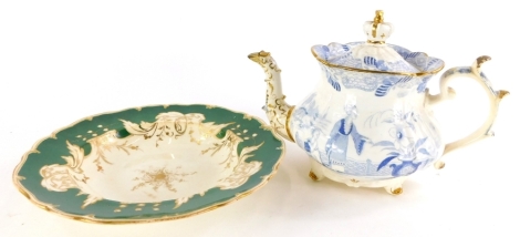 A Rockingham three spur teapot and cover, decorated in blue with oriental figures in landscape, pattern number 1106, together with a green ground Rockingham soup plate (unmarked), 25cm diameter. (2)