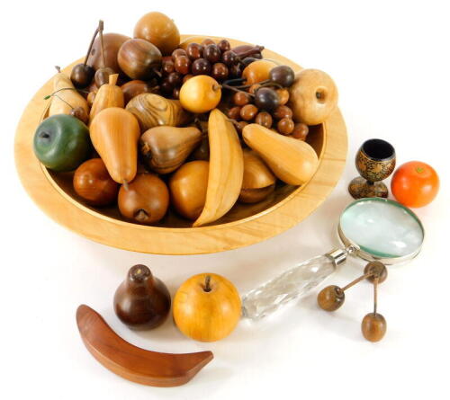 Various modern carved wooden fruit to include pears, apples, etc., a glass handled magnifying glass, and a small quantity of other treen items, glass bowl etc.(a quantity).