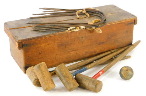 A vintage table top croquet set, in pine box, 46cm wide, to include mallets, ball and hoops, (a quantity, AF).