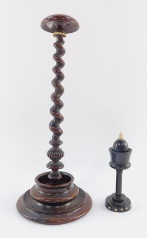 Two 19thC sewing aids, comprising an ebonised bobbin holder, with bone acorn finial and removable top, on a circular studded base, 13cm high, and a turned bobbin stand with compressed mushroom top, tapering removable barley twist stem and shaped base.