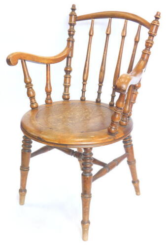 A late 19thC/early 20thC Austrian bentwood open armchair, with a spindle turned back, shaped arms and a pressed seat decorated in the Nouveau style with flowers and leaves, on turned legs.