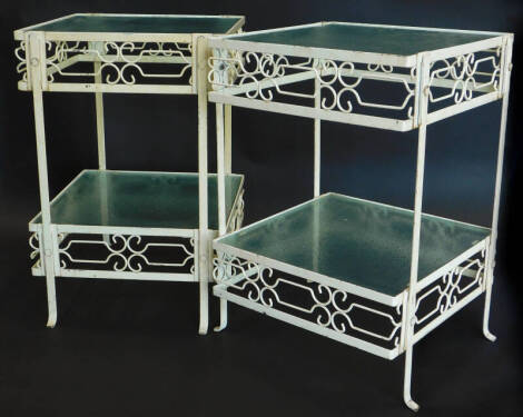 A pair of 1950's painted vintage occasional tables, in Art Deco style, each with two textured glass tiers, pierced trellis bands and splayed feet, 58cm high, 39cm wide, 41cm deep.